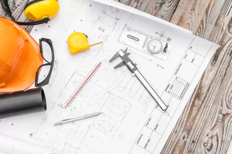 home addition plans with orange helmet